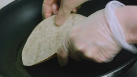 Savory kitchen view of drizzling oil into a clean frying pan Stock Footage 342152898