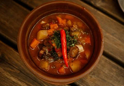 Savory lagman is presented with chunks of beef colorful vegetables and a touch Stock Photos