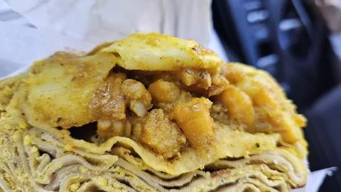 Savory layers of flatbread filled with spiced potatoes and chickpeas. Stock Photos