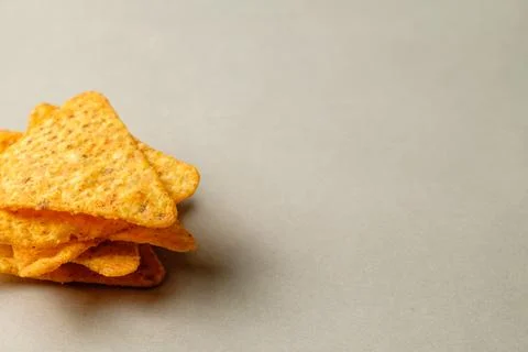 Savory nacho chips piled invitingly on a smooth surface for sharing Stock Photos