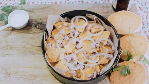 Savory overhead composition: arranging the mixture in a baking dish Stock Photos
