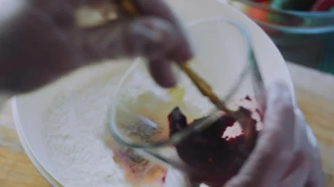Savory tabletop moment: turning red beet dough in a bowl Stock Footage 342173457