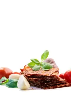 Savory tomato sheets with basil and garlic on white background Stock Photos