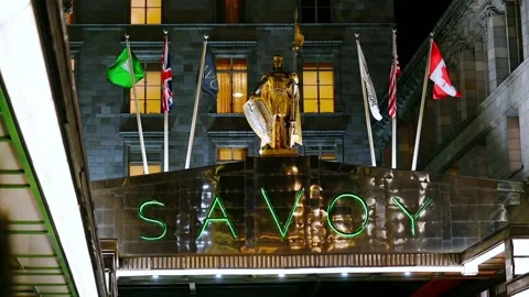 Savoy Peter Statue and flags above the front entrance to The Savoy Hotel, Lon Stock Footage 131795446
