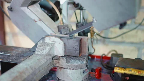 Saw of automated cutting machine cutting metal plank under the angle using Stock-Footage 264767566