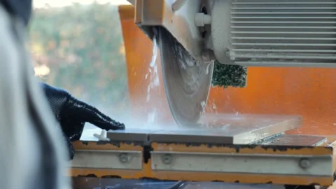 Saw blade cutting deck tiles.Close-up of deck tiles being cut with a saw. Stock Footage 326240600