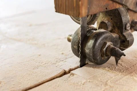  saw blade guide Closeup of the mechanical guide of the saw blade of an ol... Stock Photos