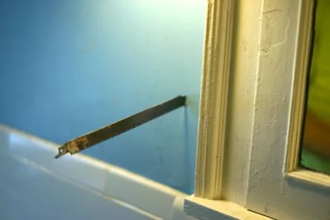 A saw blade in the wall. Stock Photos