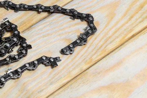 Saw chain broken after misuse needs to be replaced Stock Photos