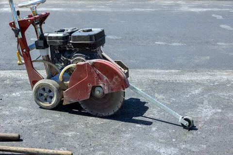 Saw machine used for cutting pavement in construction site Stock Photos