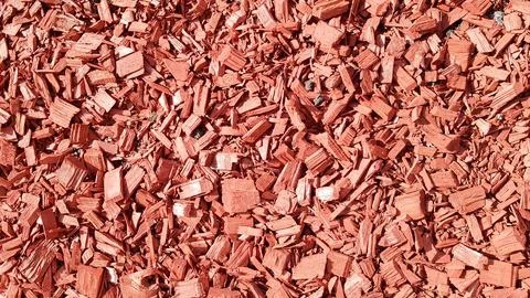 Sawdust for the garden. Texture of tree bark lying on the ground. Backgroun.. Stock Photos