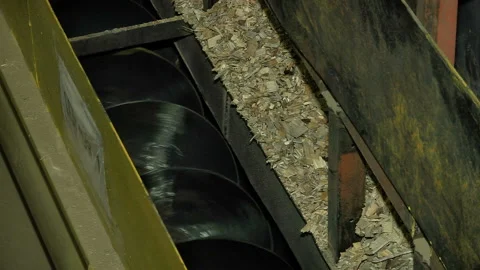 Sawdust spilling from the hopper to the auger Stock Footage 85650201