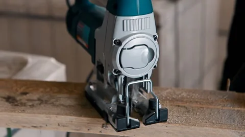 Sawing a board with the help of a jig saw Stock Footage 61280341