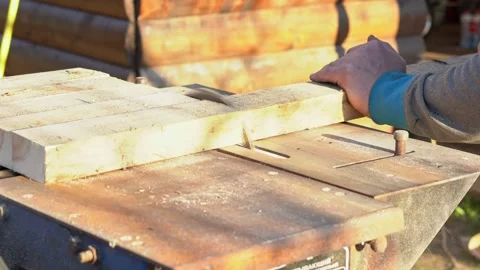 Sawing boards circular saw. The work of the joiner in the open air. Closeup Stock Footage 130691156