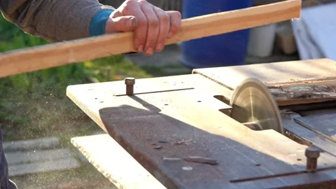 Sawing boards circular saw. The work of the joiner in the open air. Closeup Stock Footage 138788831