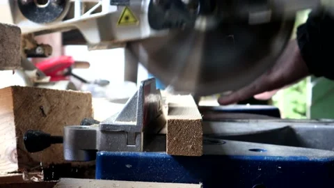 Sawing Through A Block Of Wood With A Pull Down Circular Saw 스톡 동영상 138109942