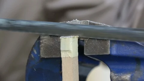 Sawing through metal using vice, close up Stock Footage 98082159