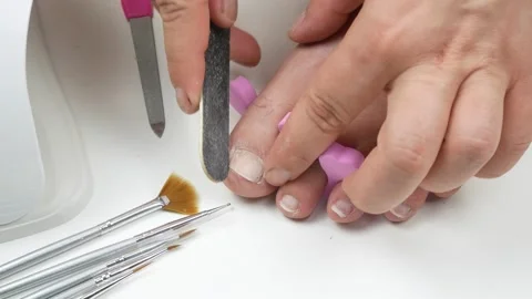 Sawing toenails.On the table of the diamond nail files and brushes for design. Stock Footage 136428064