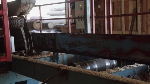 Sawmill machine cutting wood log board, rolling metal cylinders Stock Footage 85199362