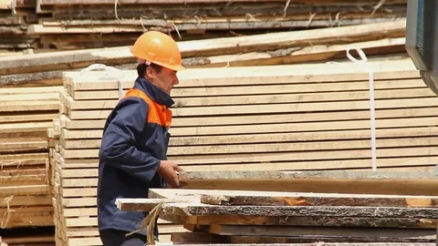 Sawmill. The worker puts the boards. Stock Footage 74430560
