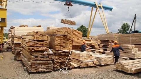 Sawmill. Workers put boards. Crane works Video stock 74430502
