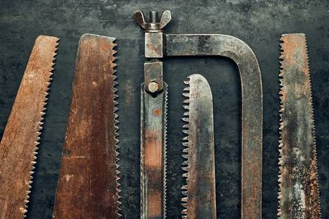 Saws on metal surface. Rusty tools for maintenance. Hardware to fix. Techni.. Stock Photos