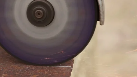 Saws a sheet of metal with an angle grinder Stock Footage 73605559