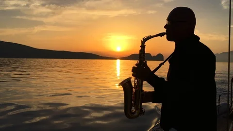 Sax man at sunset Stock Footage