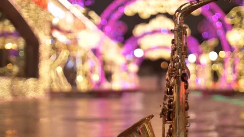 Saxophone on a background of night illumination from light bulbs Stock Footage 84393343