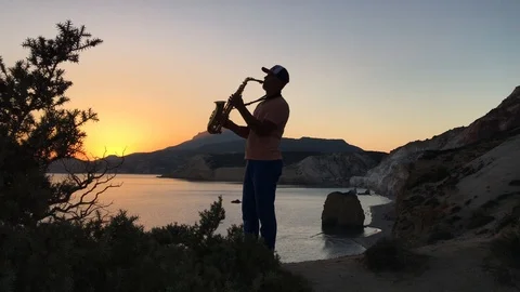 Saxophone man at sunset  Stock Footage 86563753