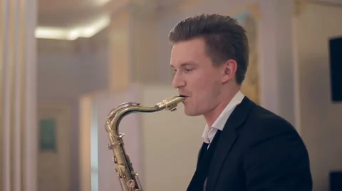 Saxophone player performs on stage. Medium profile shot. Stock Footage 40686414