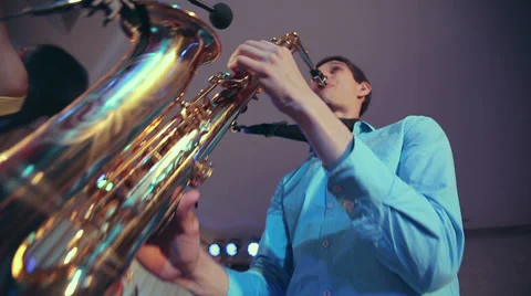 Saxophone player performs on stage with professional light. Close up wide angle Stock Footage 39614905