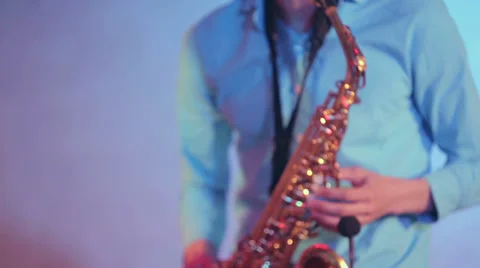 Saxophone player performs on stage with professional light. Front shot. Close up Stock Footage 39615574