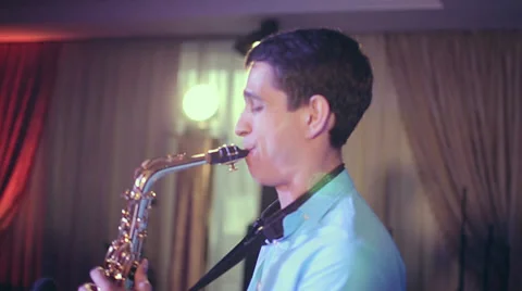 Saxophone player performs on stage with professional light. Profile shot. Stock Footage 39619137