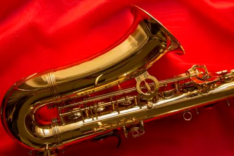 Saxophone on a red silk 스톡 사진