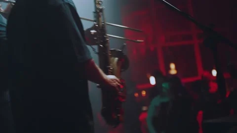 A saxophonist dancing on stage Stock Footage 165701262