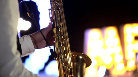 A saxophonist playing at dusk Stock Footage 287573404