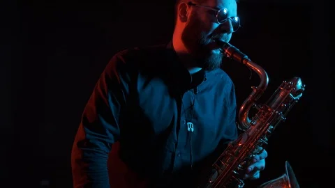 Saxophonist plays the saxophone, black background, isolated Video stock 127053953