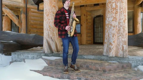 Saxophonist plays the saxophone, in winter Stock Footage 87653759
