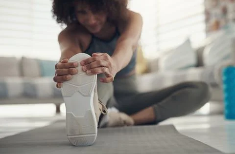 Say goodbye to stiff hamstrings. Defocused shot of a young woman sitting alone Stock Photos