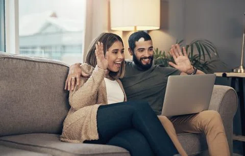 Say hello to the world without leaving your home. a young couple using a laptop Stock Photos