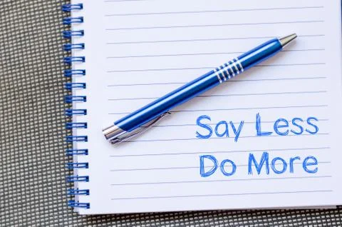 Say less do more concept on notebook Stock Photos