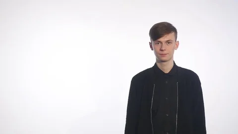 Saying hello to someone. Handsome young men greeting someone isolated on white Stock Footage 73725243