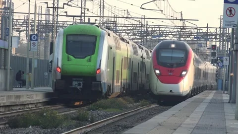 SBB-FFS Giruno train meets Trenord Hitachi train at Milan Forlanini station Stock Footage 292640963