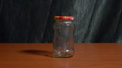 SBlack hands closing an empty glass jar Stock Footage 276594094