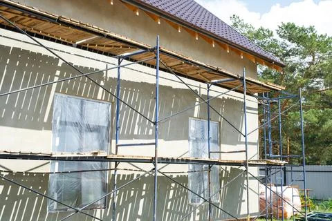 Scaffolded house under facade render, external plaster finishing, insulatio.. 스톡 사진