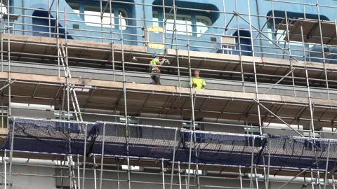 Scaffolders working on a tall building Stock Footage 272986280