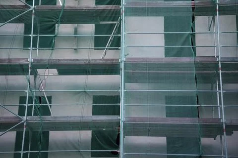 Scaffolding and protective construction of multi-storey building. Stock Photos