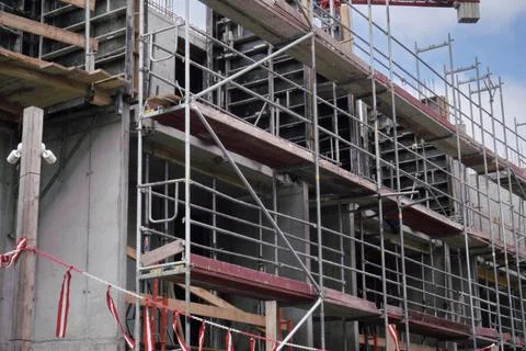 Scaffolding around the new building. development new blocks. Stock Photos