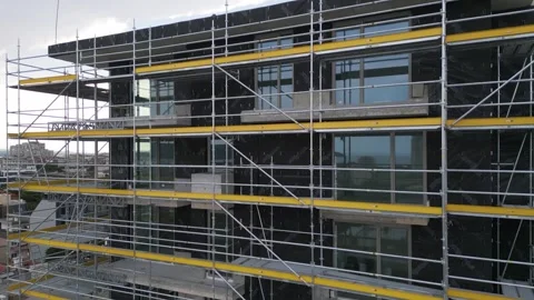 Scaffolding on Building Facade Under Construction for Renovation Work Stock Footage 345157791